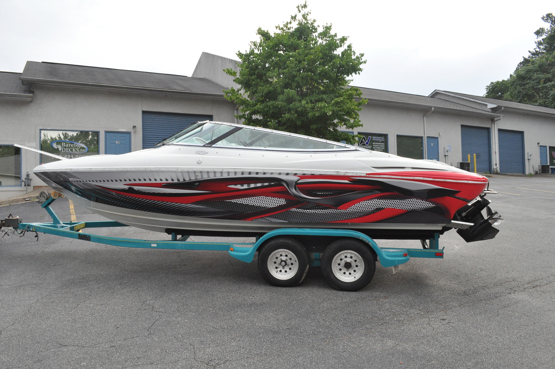 Speedboat with installed red, black, and silver custom graphics.